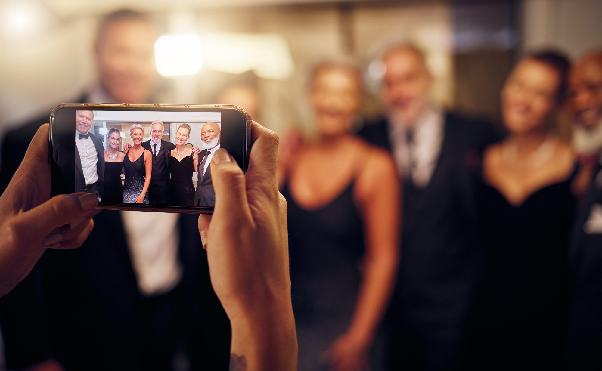 Friends gathering for photographs at a formal wedding celebration