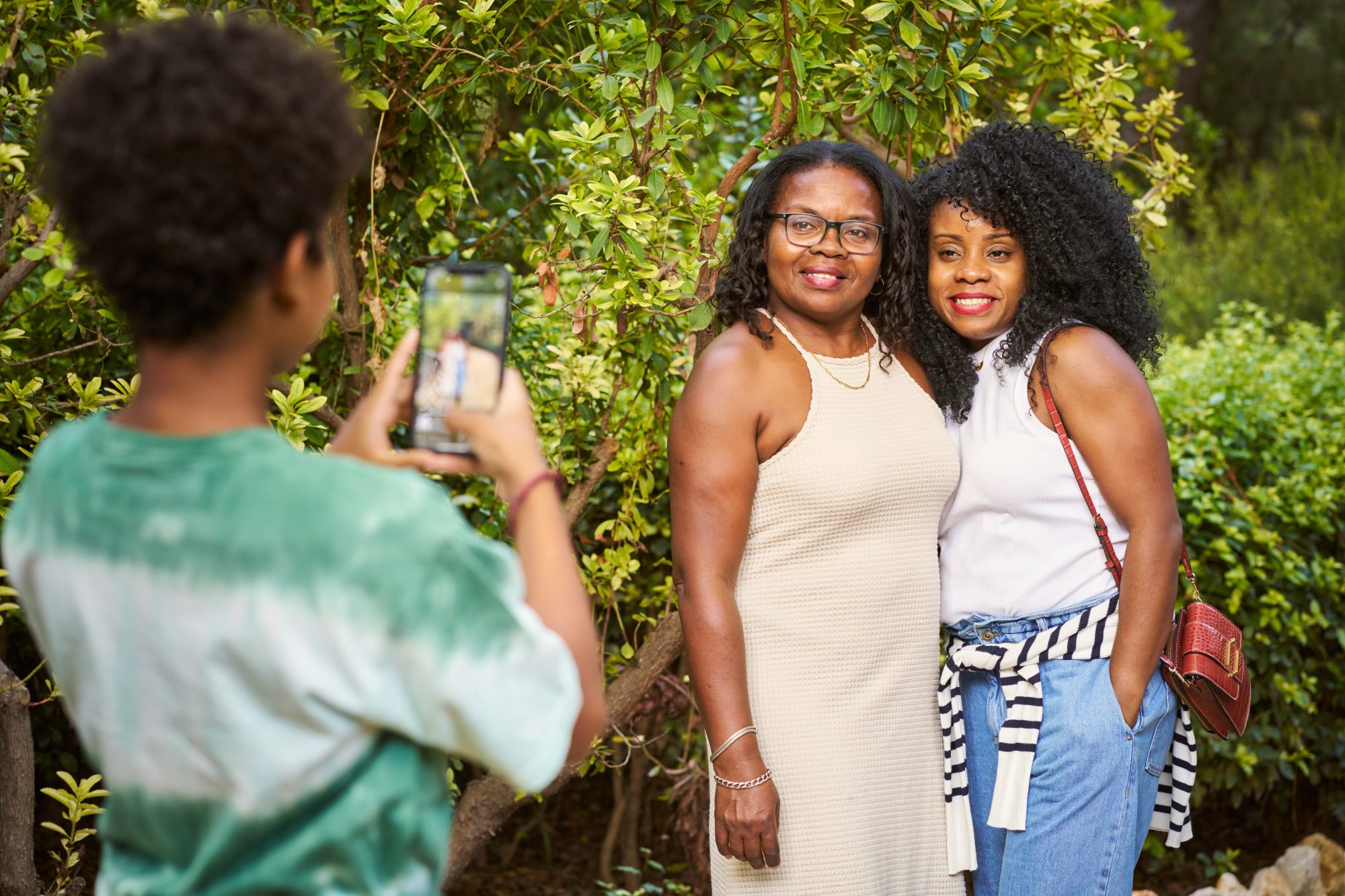 Family taking a photograph together in a green wedding garden