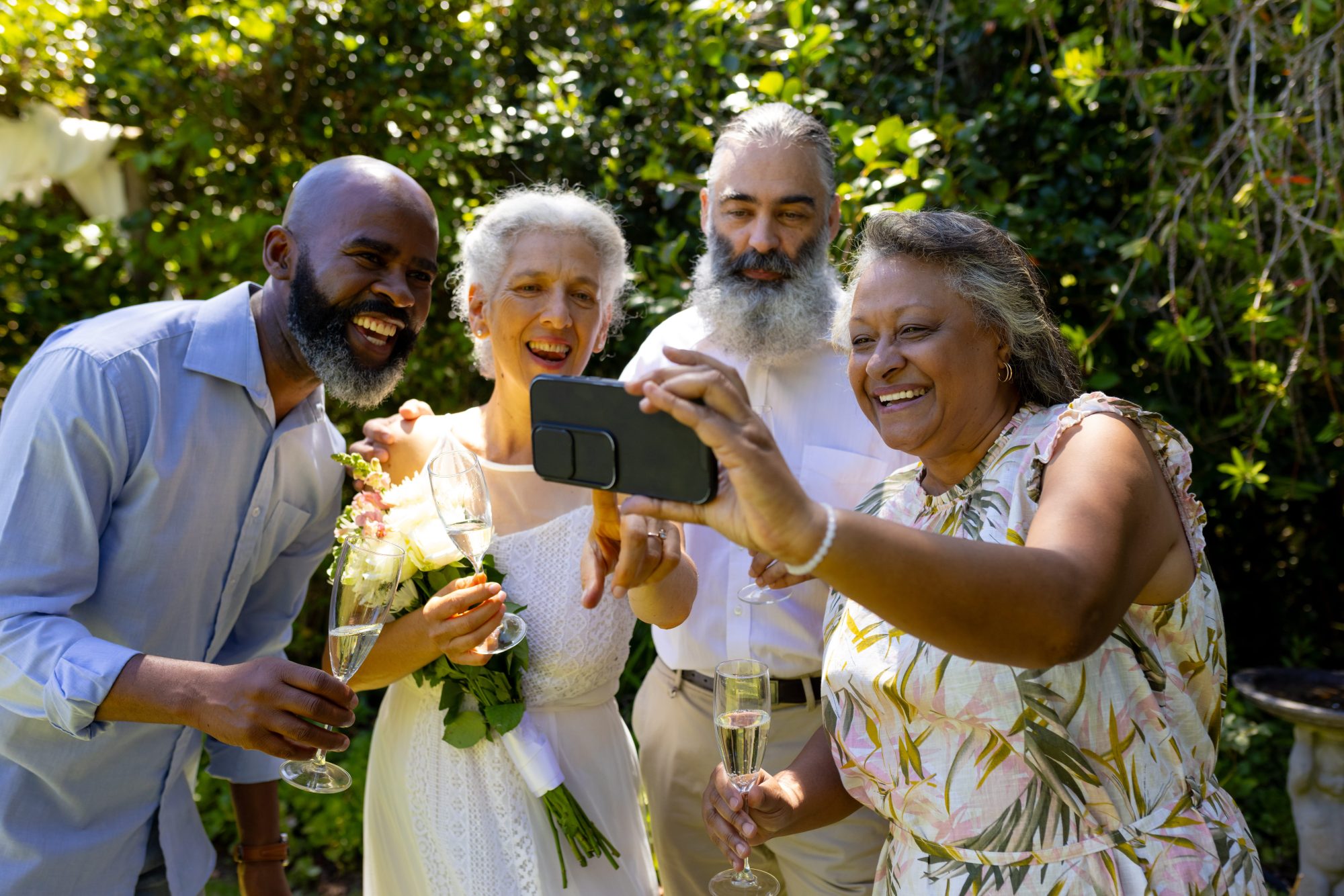 Wedding couple celebrating naturally with smiling friends