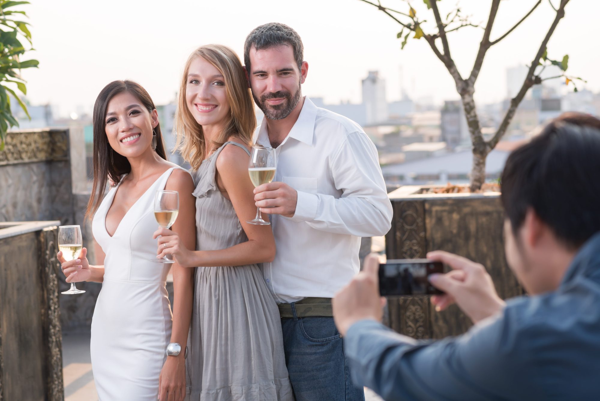 Friends celebrating and taking candid photographs at a party