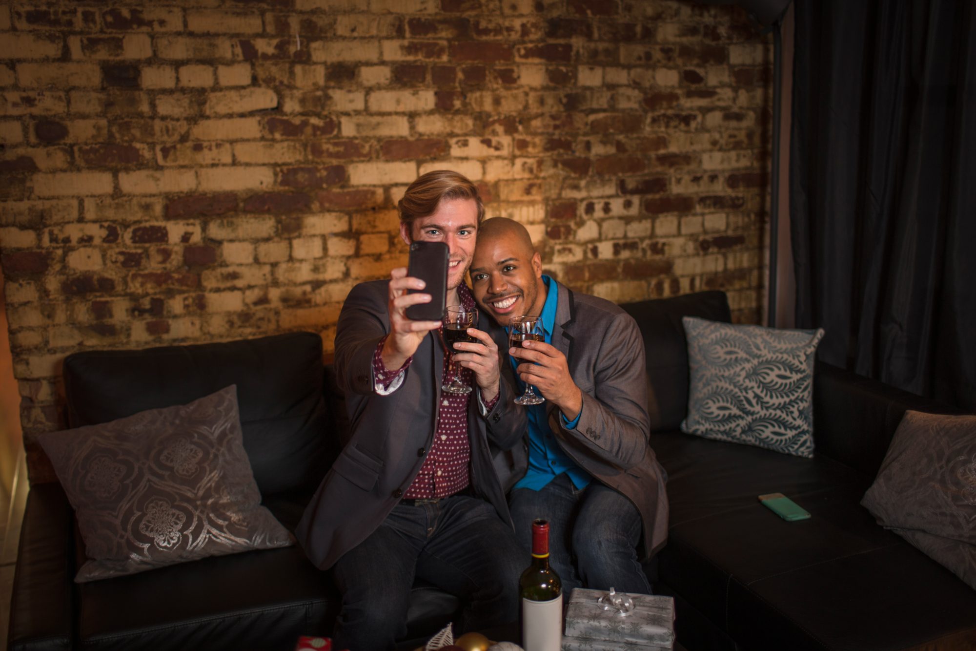 Two guests taking a wedding selfie before sharing the photograph