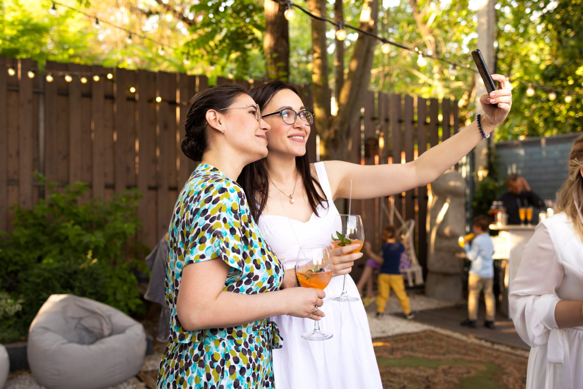 Wedding guests toasting and taking a photograph outdoors